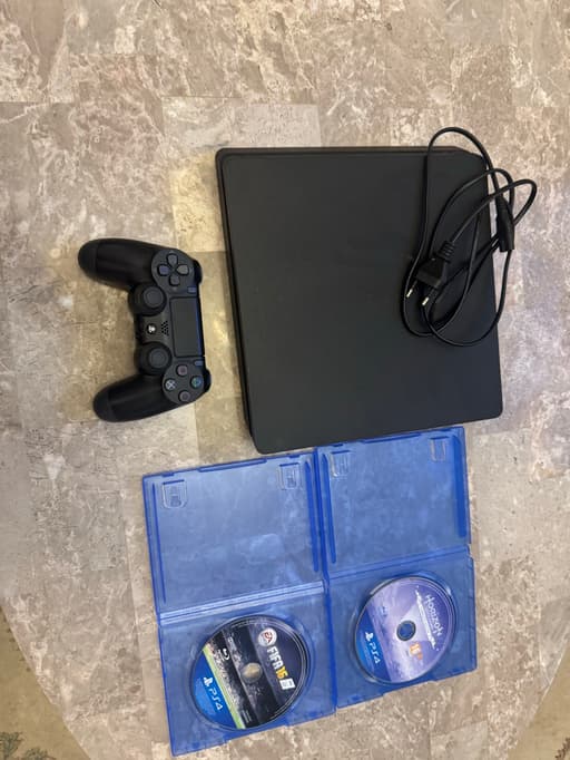 PS4 SLIM 500 GB with controller and all cables with 2 games .